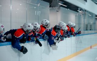 Young hockey players on outdoor ice, ready for winter sports season after a sports physical