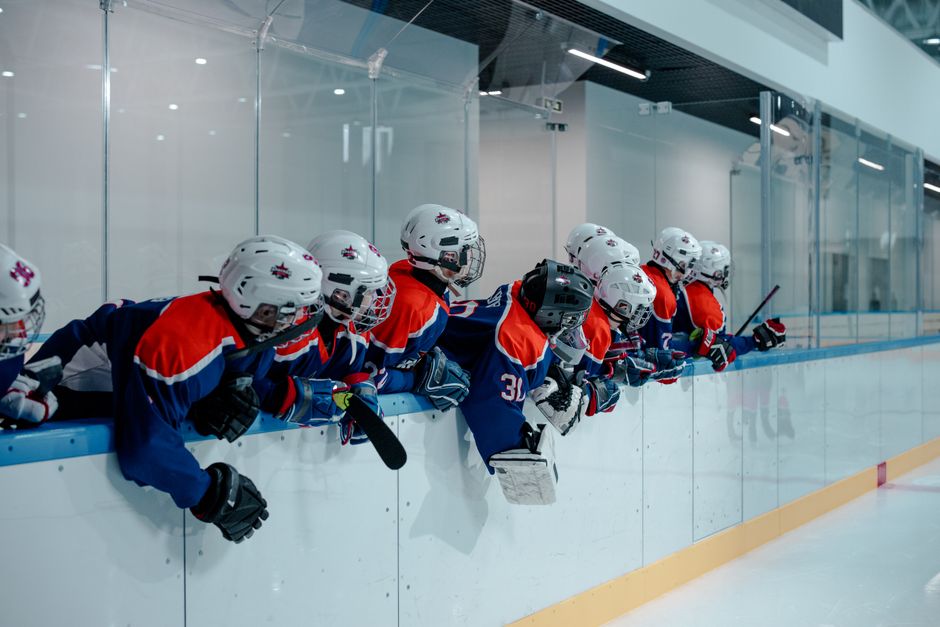 Young hockey players on outdoor ice, ready for winter sports season after a sports physical